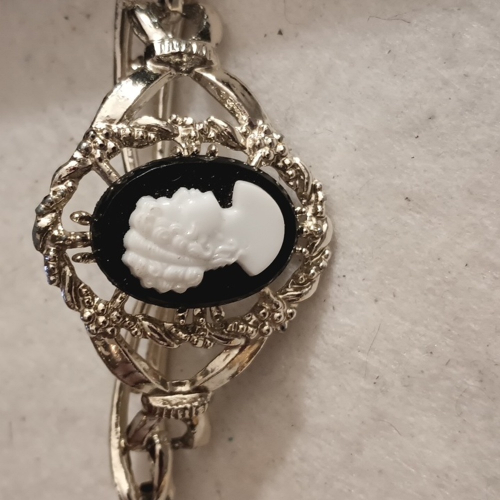 Silver tone black and white Cameo bracket